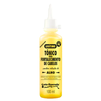 Tônico Gota Dourada 100mL, frasco amarelo e bico aplicador. Com extrato de alho, fortalece a raiz e combate a queda.